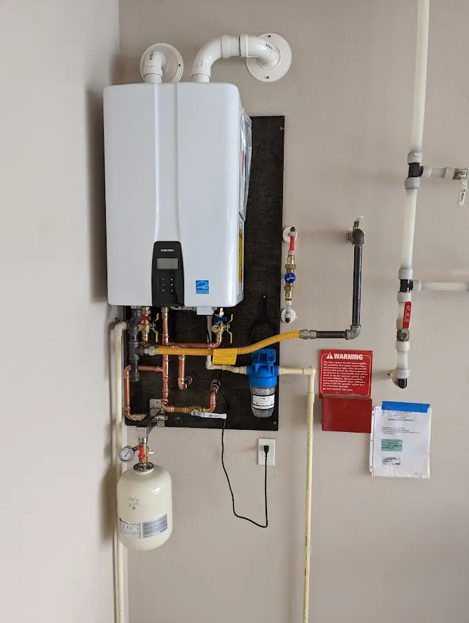 Professional plumber installing copper piping in a Bardmoor home